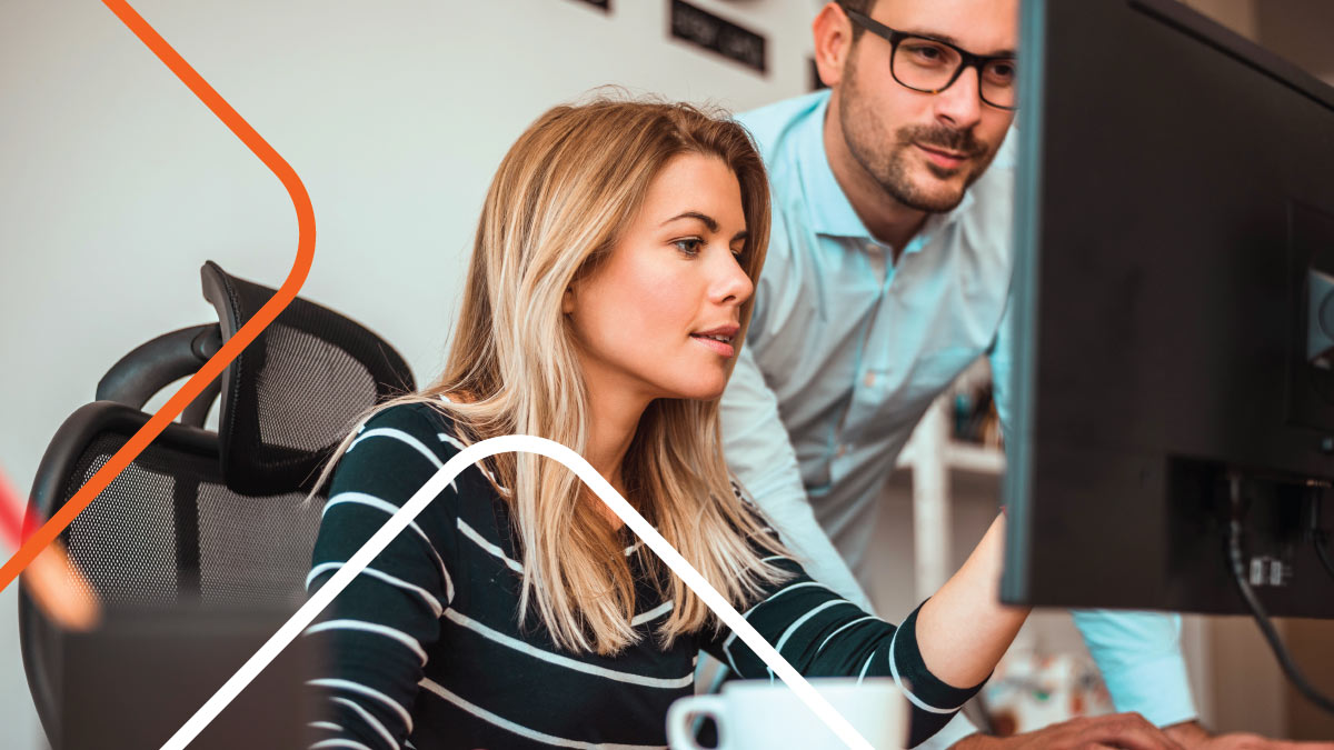 Coworkers in an office looking at computer screen