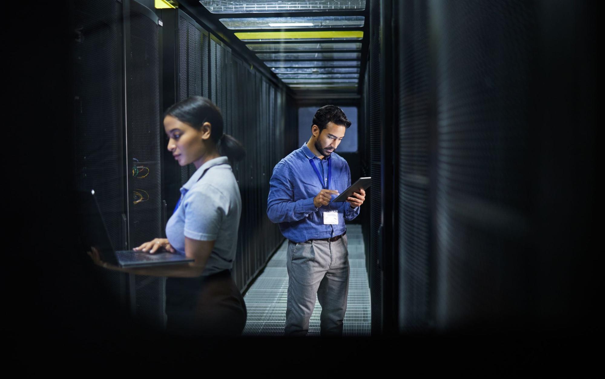 Two technicians in a server room